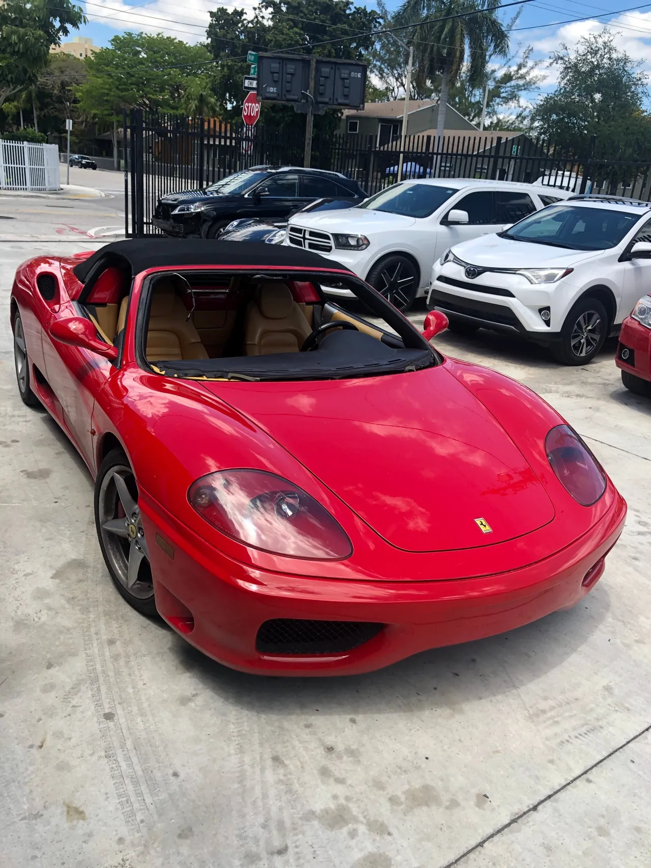 A red Ferrari 360 Spider outside Giant Motors