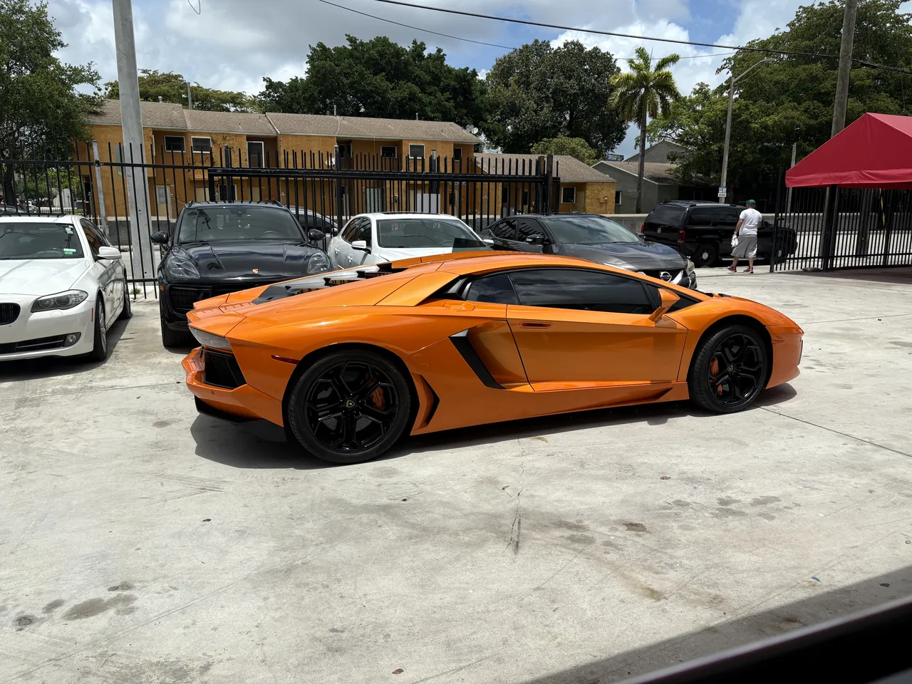 An orange Lamborghini Aventador outside Giant Motors