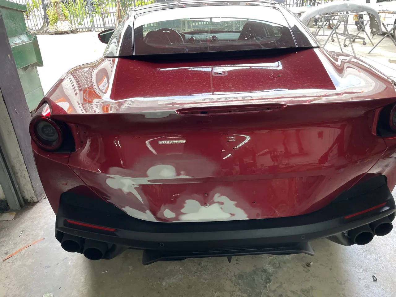 A Ferrari Portofino with rear damage, waiting for its estimate at Giant Motors