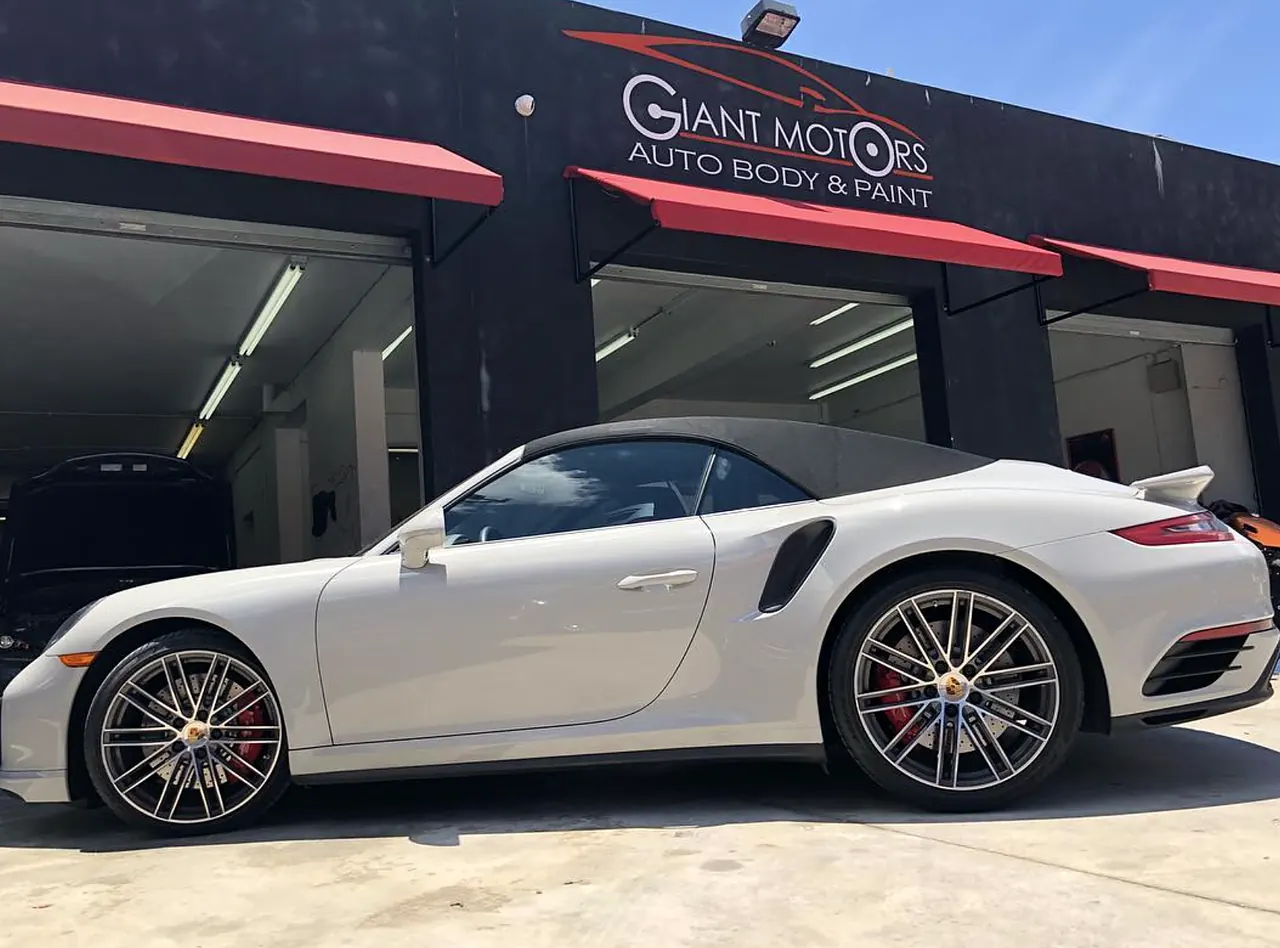 A white Porsche 911 Turbo Cabriolet outside Giant Motors