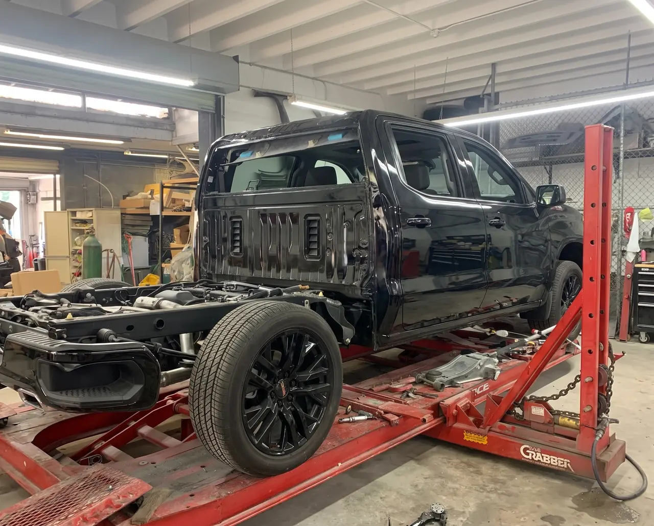 A pickup truck on the frame rack at Giant Motors