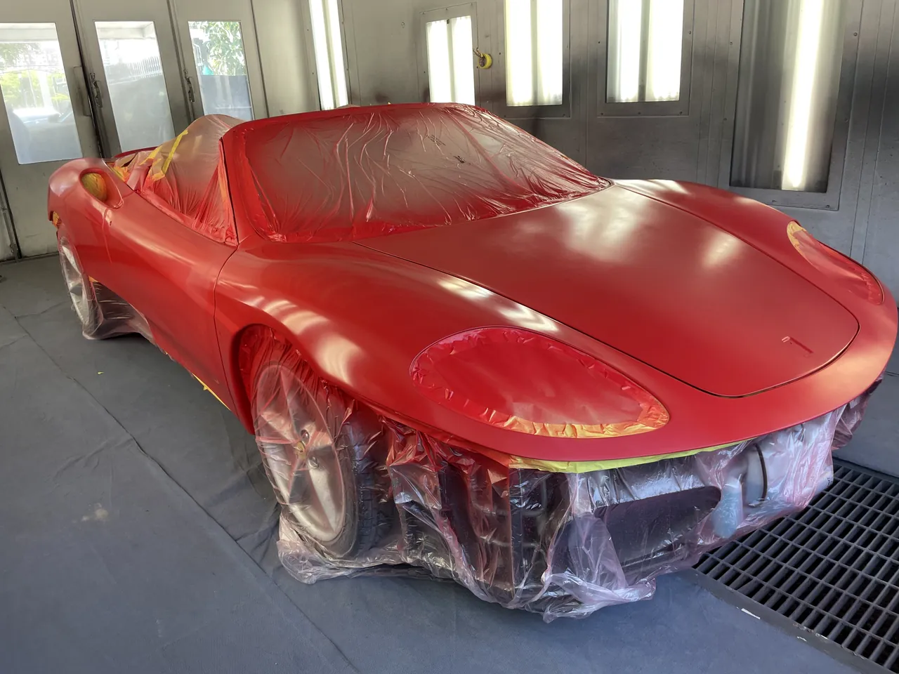 A Ferrari freshly painted red in the Giant Motors paint booth