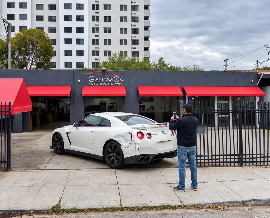 A customer photographing the damaged GT-R outside Giant Motors